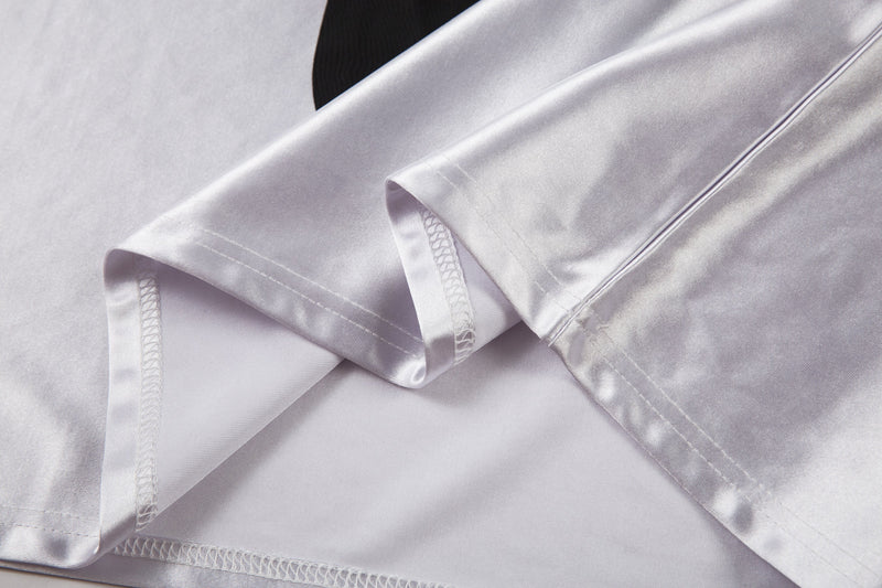 Close-up of white jersey hem and sleeve cuff with stitched edges