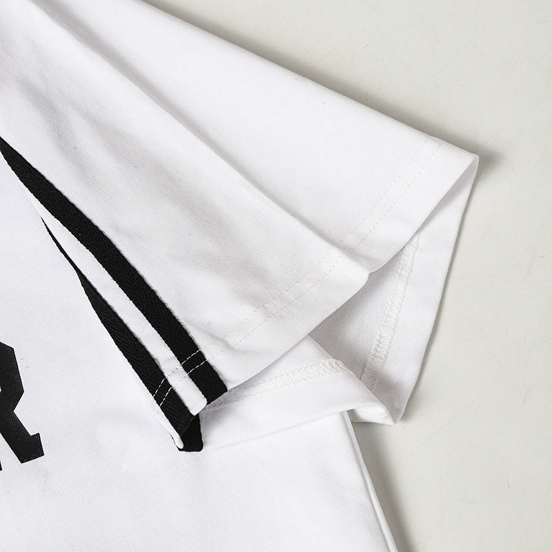 White cotton jersey sleeve with black side stripes and stitched hem detail on a football-inspired men’s shirt