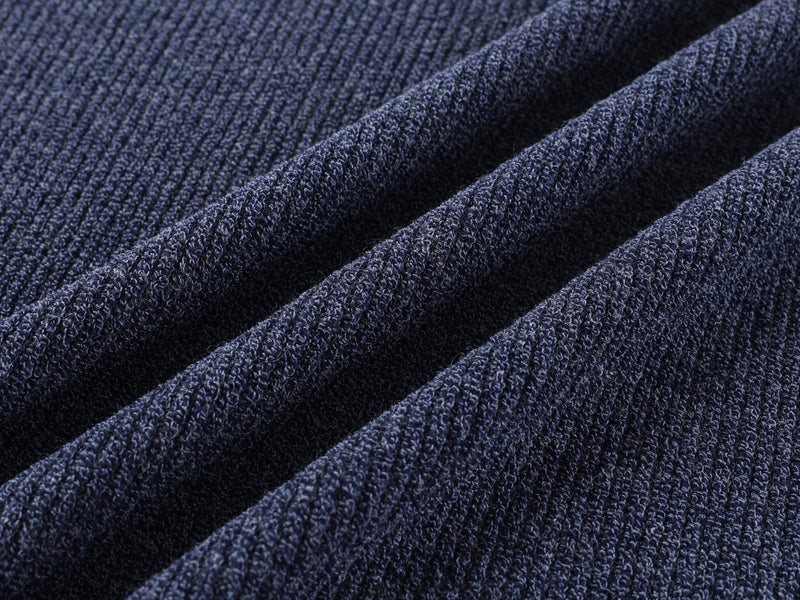 Close-up of navy ribbed knit sleeves with soft textured drape