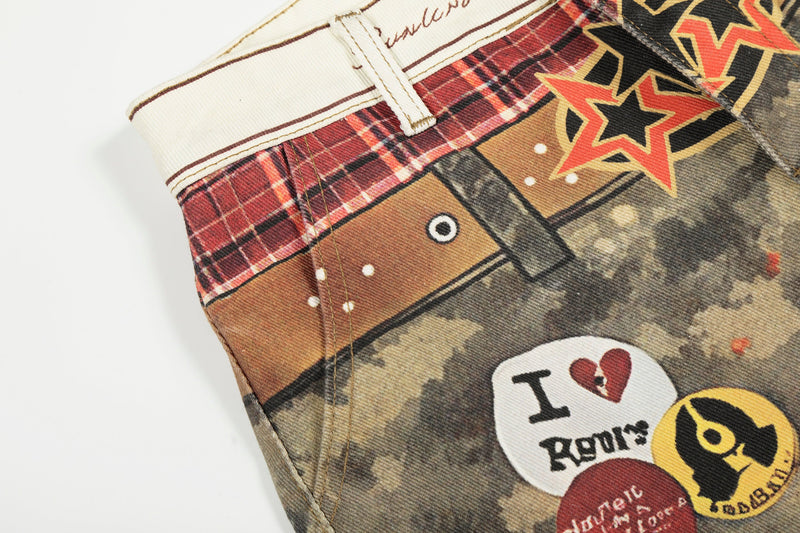 Close-up of back waistband and upper pocket on camo patchwork denim pants with patch graphics