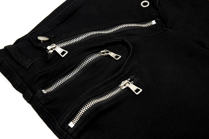 Close-up of layered front zippers on black pants waistband