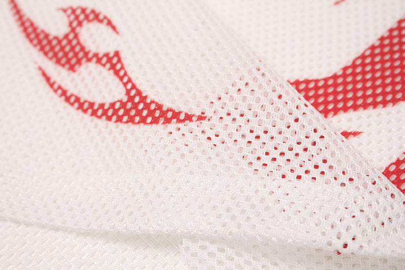 Close-up of white mesh jersey fabric with red flame sigil print and breathable athletic texture
