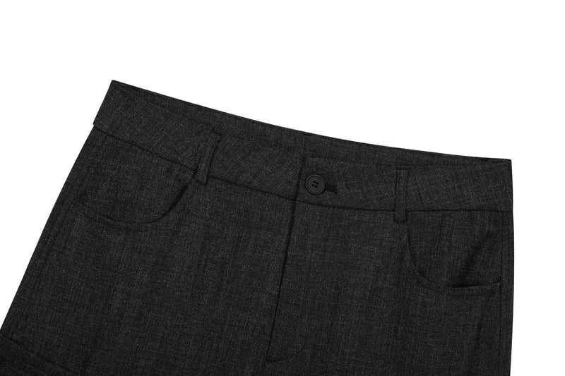 Close-up of black cargo pants waist with button closure, belt loops, and front pocket