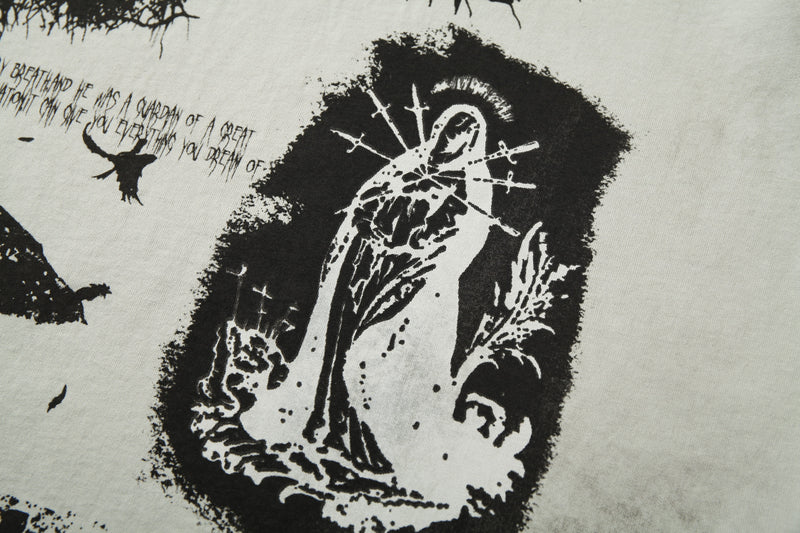 Distressed black-and-white graphic tee with eerie hooded figure, birds, and handwritten text print on a light raglan shirt