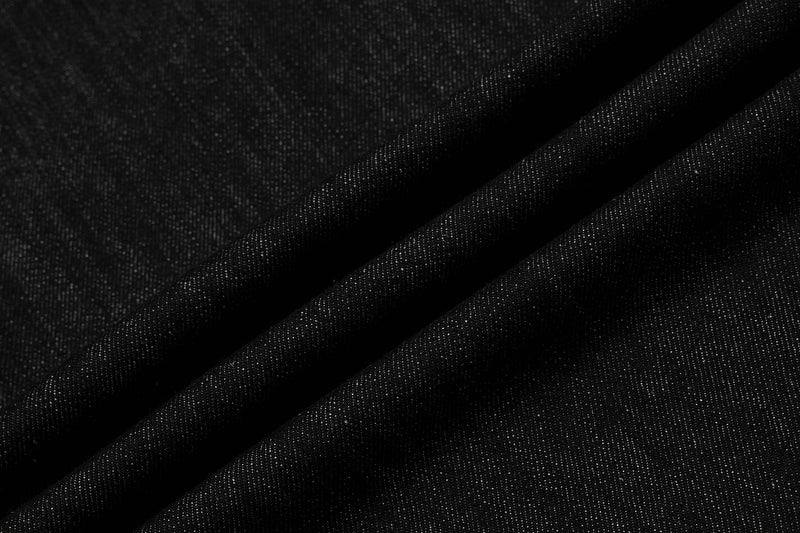 Close-up of black denim fabric folds and weave texture