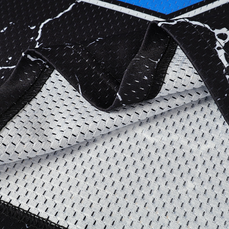 Close-up of a black street football jersey with flame crack print and breathable white mesh fabric