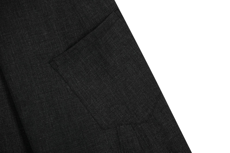Close-up of black cargo pants side seam and cargo pocket on textured fabric