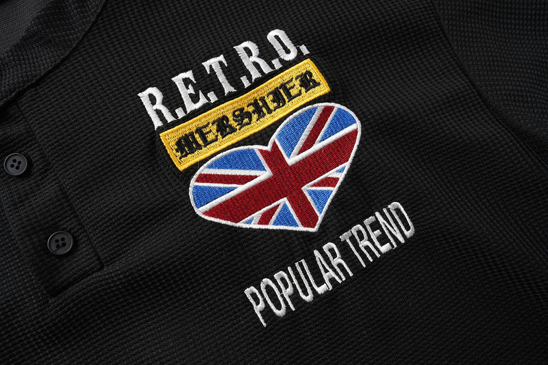 Close-up of retro chest patch and Union Jack heart on black Henley shirt
