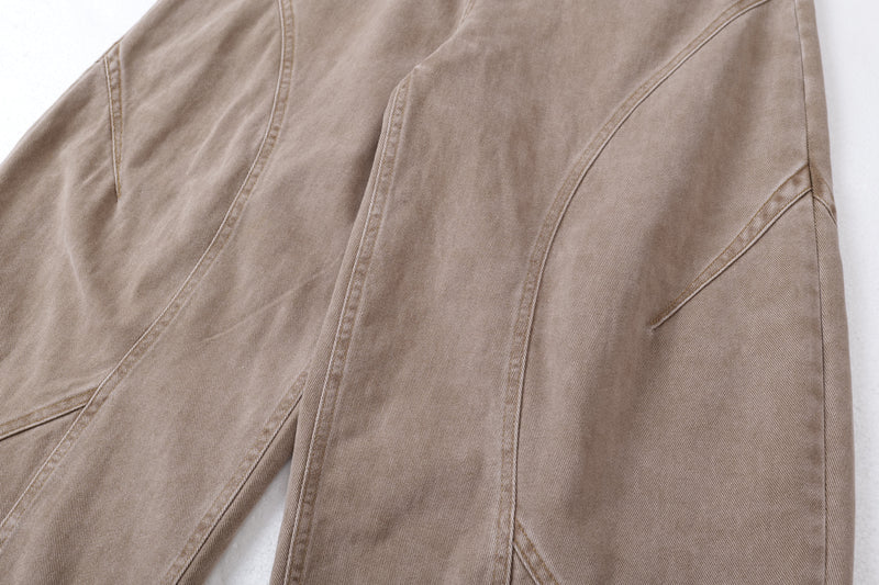 Close-up of tan jeans side seam and sculpted panel stitching