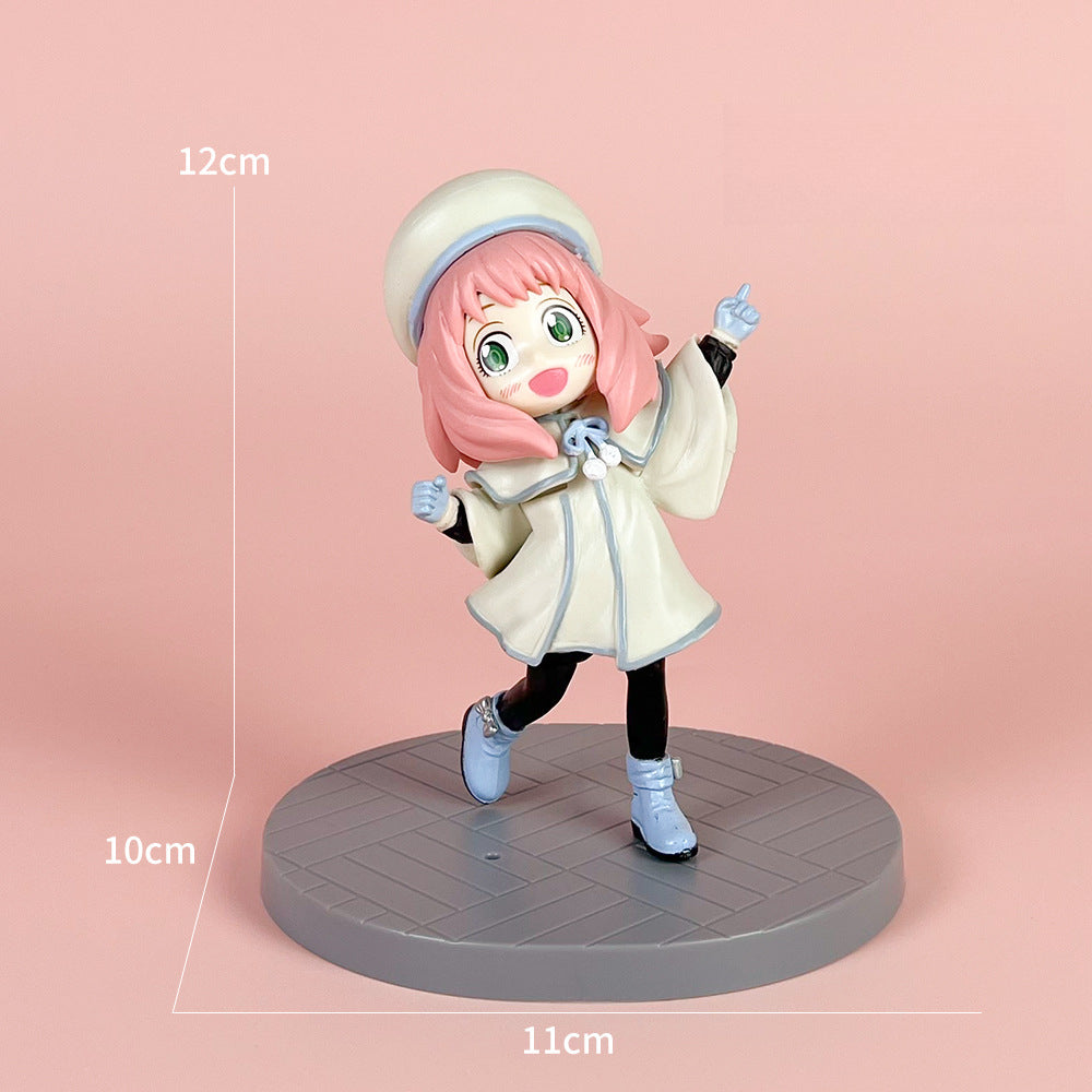 The Spy x Family Detective Anya PVC figure set features a 14 cm tall movie version of Anya in four poses. This pink-haired character is elegantly posed with a white beret and outfit, atop a round gray base against a light pink backdrop.