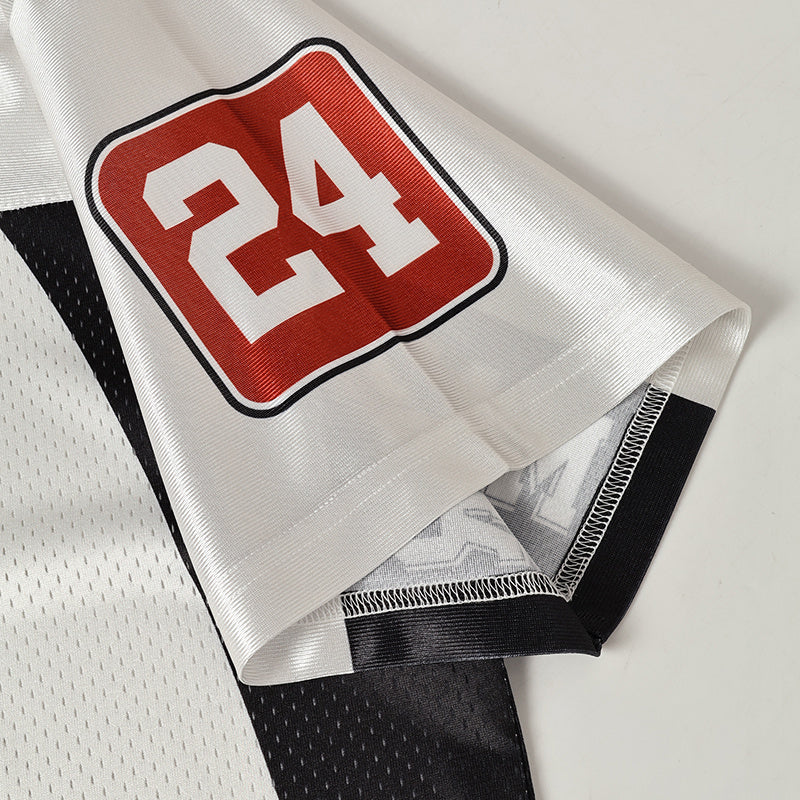 White football jersey sleeve with bold red 24 varsity number and black trim, showing sporty streetwear details