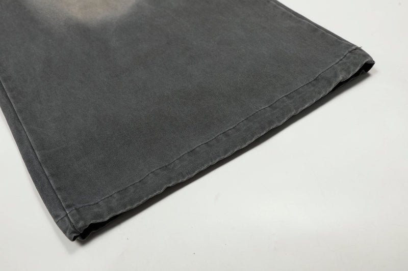 Close-up of wide pant leg hem on washed charcoal cargo trousers