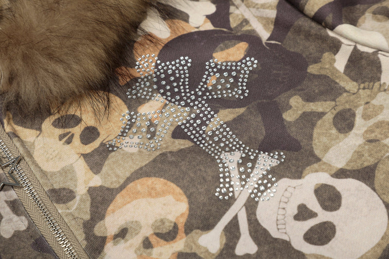 Close-up of rhinestone cross skull design on camouflage jacket front