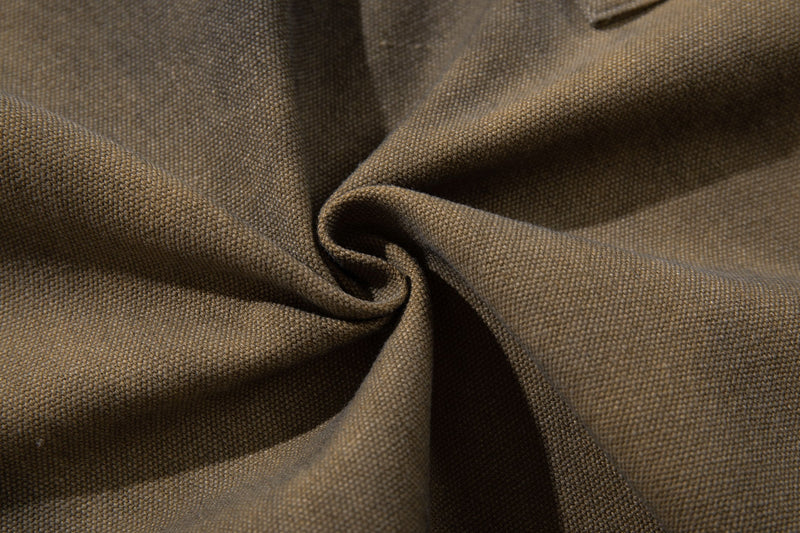 Close-up of olive brown woven fabric texture on cargo shorts