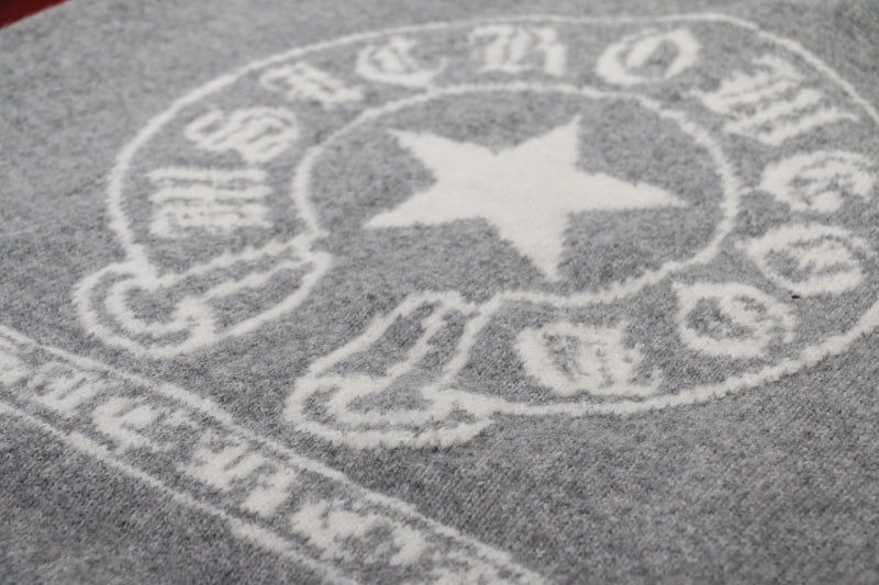 Close-up of back graphic on gray knit hoodie with white star and circular print