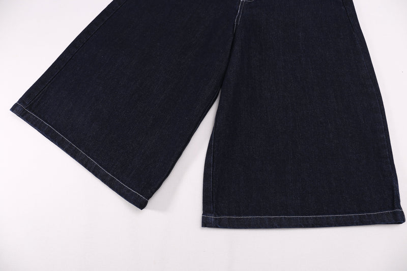 Wide-leg dark denim shorts shown from the hem with clean stitched cuffs