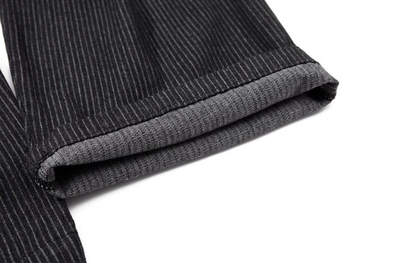 Close-up of cuffed hem on black pinstripe trousers with lighter underside