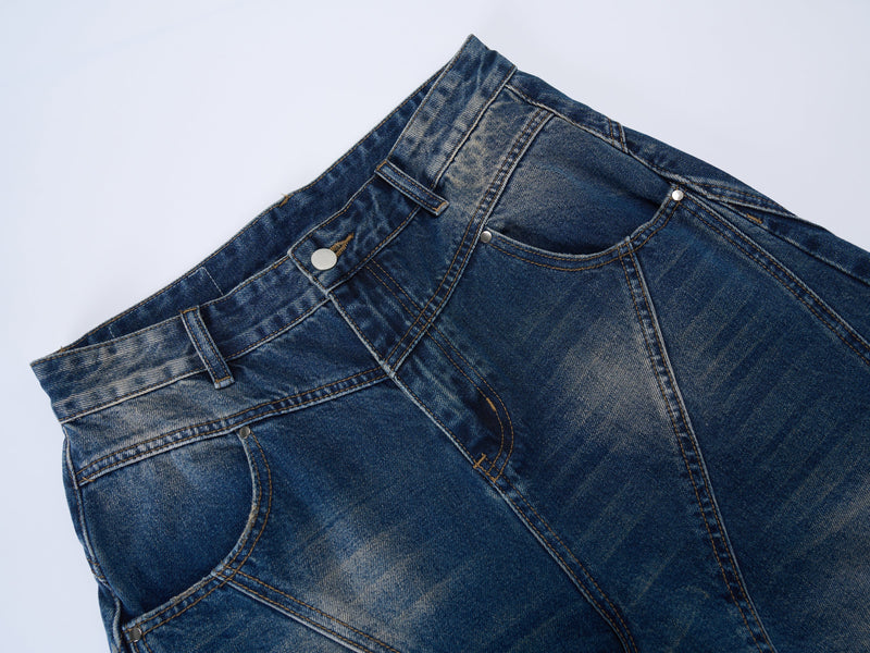 Close-up of the front waistband on blue jeans with button closure and belt loops