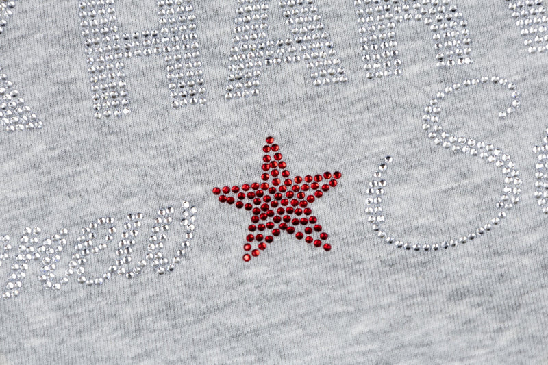 Close-up of rhinestone star and Dark Harvest lettering on heather gray fabric