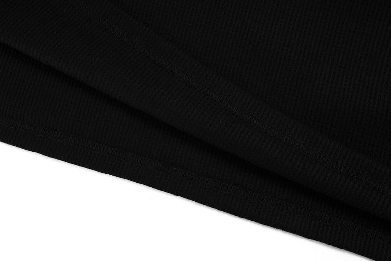 Close-up of black ribbed fabric hem on layered long sleeve tee