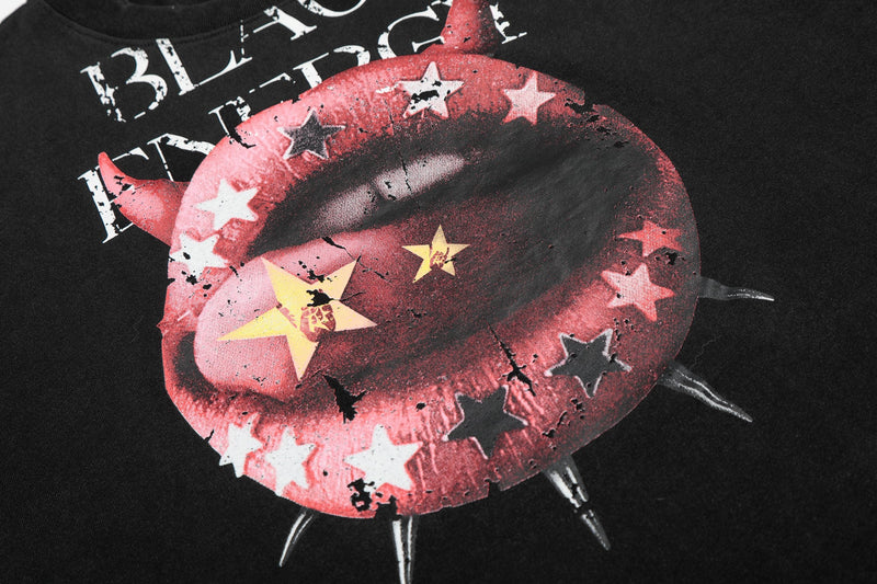 Black graphic tee with a large red devil lips print, star accents, and edgy punk streetwear styling