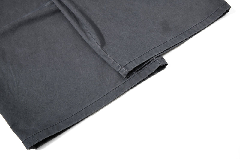 Close-up of dark gray pant cuff and hem stitching