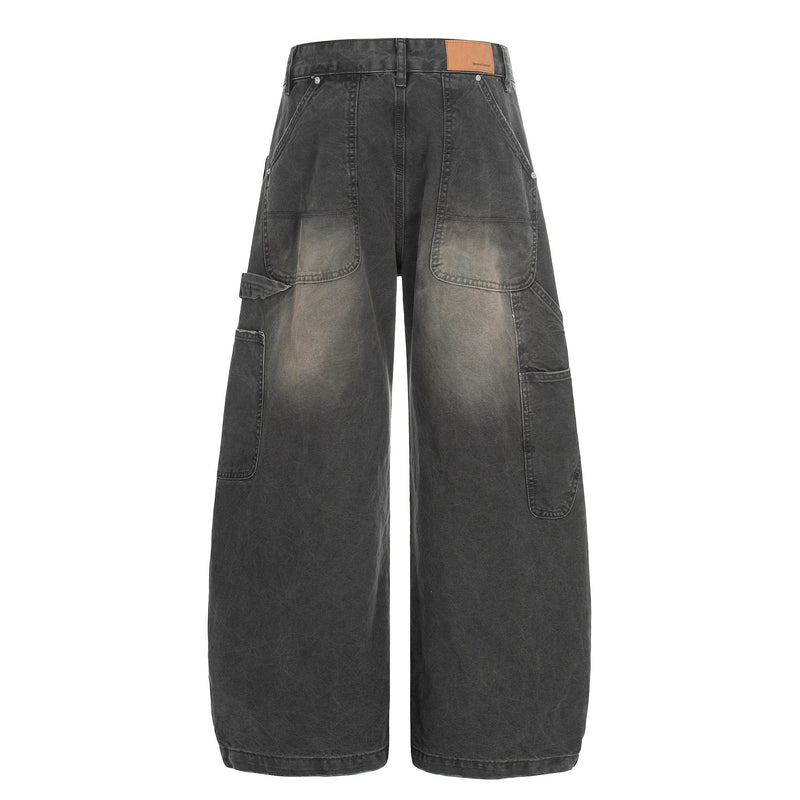 Back view of washed black wide-leg cargo denim pants with large rear patch pockets