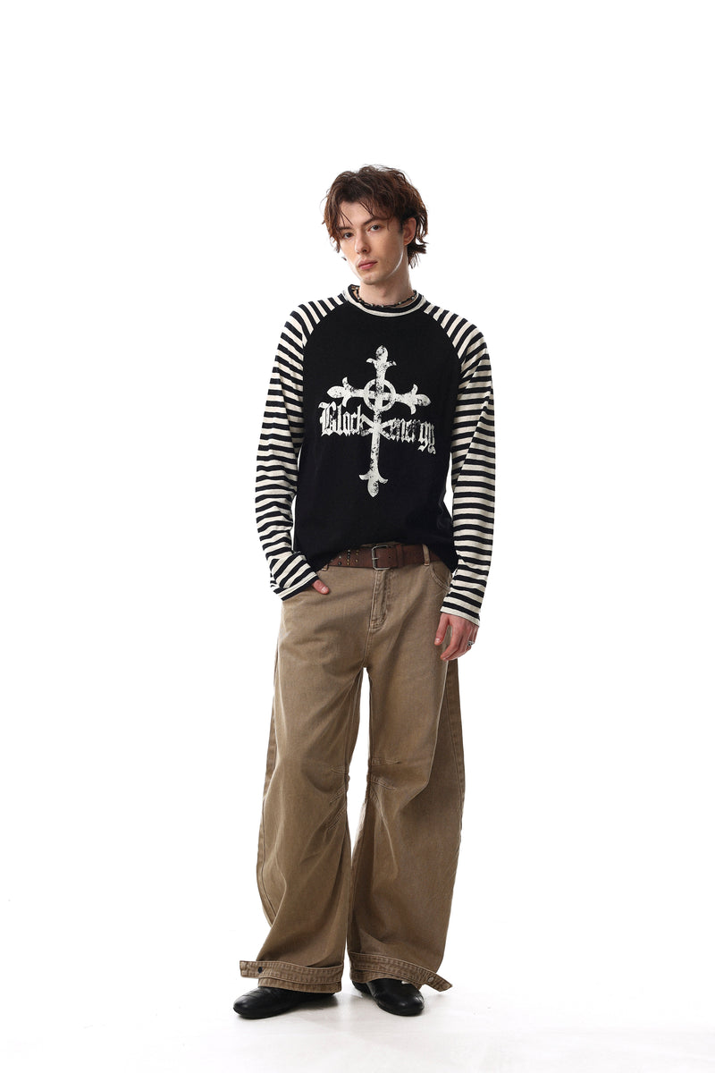 Front view of black raglan tee with cream striped sleeves and white gothic cross graphic