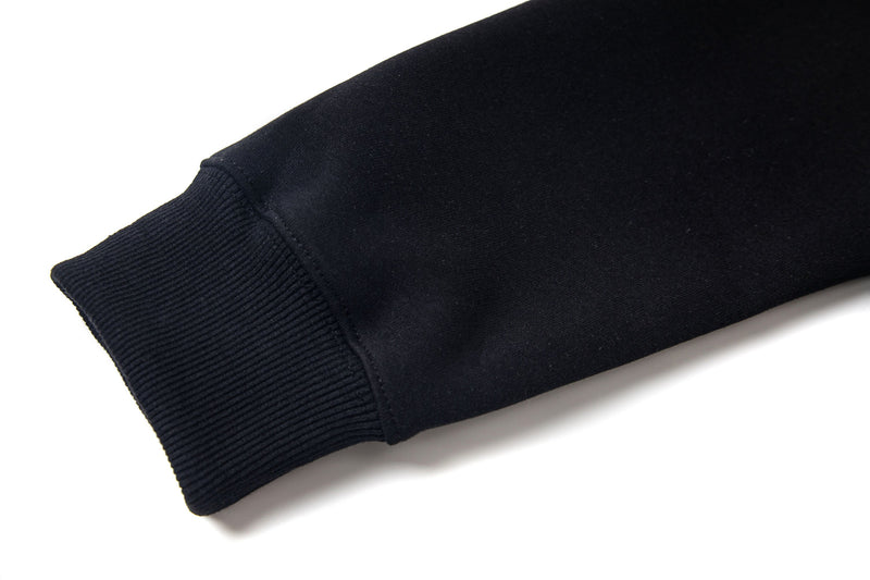 Close-up of black ribbed sleeve cuff and hem with smooth sweatshirt fabric