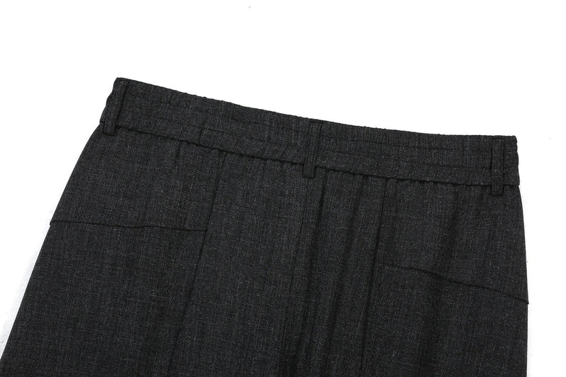 Back waist close-up of black pants with belt loop and pocket detail