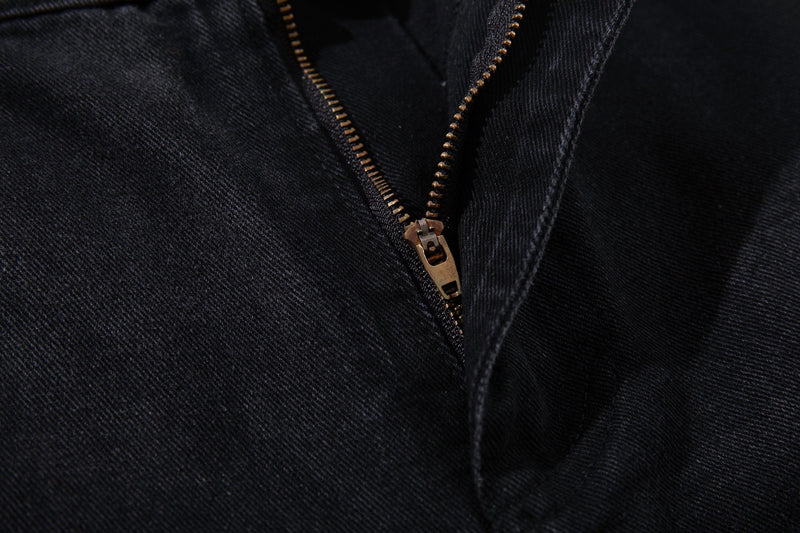 Close-up of the zipper fly on dark denim jeans