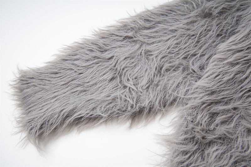 Close-up of gray shaggy knit sleeve and shoulder seam