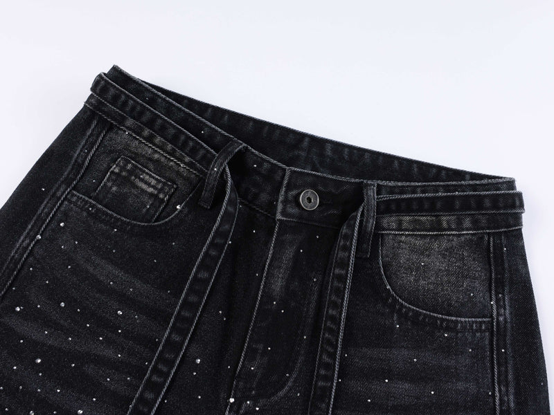 Black denim waistband and front pocket close-up with rhinestones and belt loop