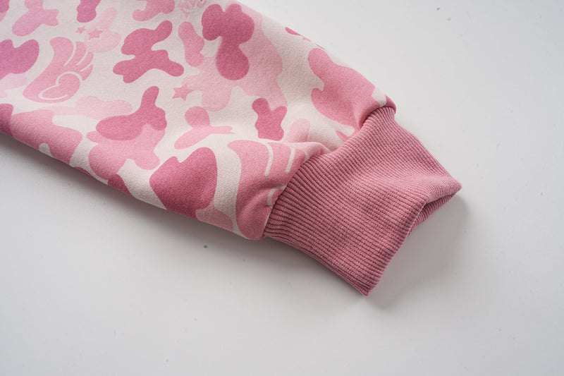 Close-up of pink ribbed cuff on camo hoodie sleeve