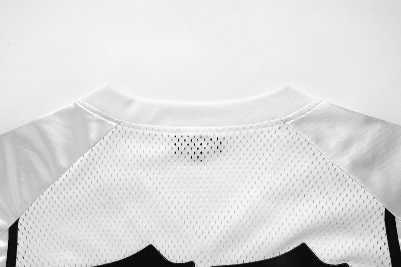 Close-up of the back neckline on white mesh jersey with satin shoulder panels