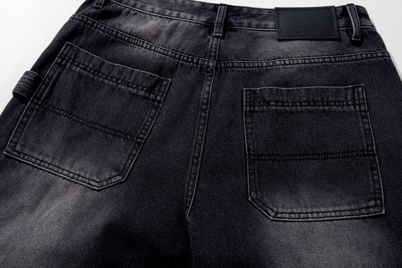 Back pockets close-up on dark wash wide-leg jeans with brushstroke fade