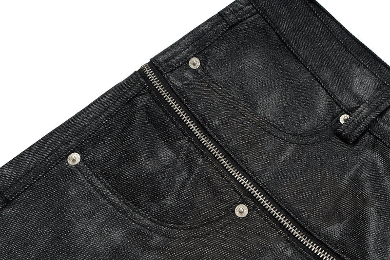 Black coated denim front pocket area with zipper and rivets