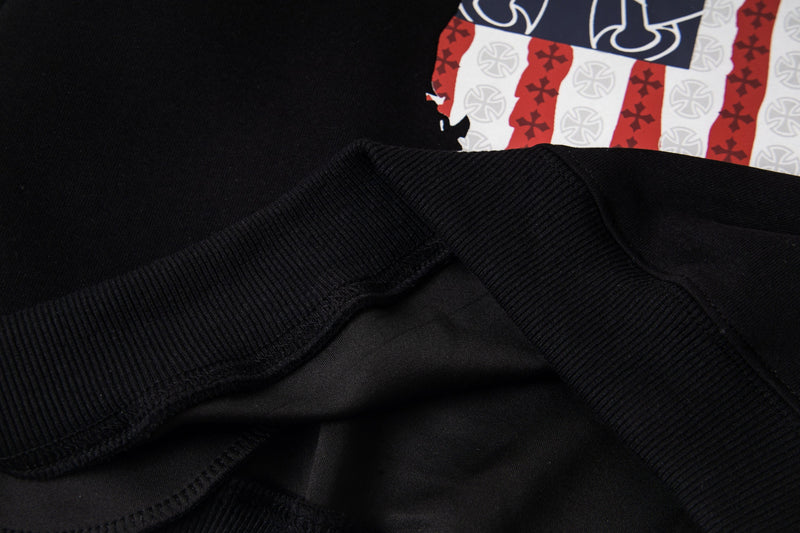 Close-up of black sleeve and ribbed cuff overlapping the front flag graphic