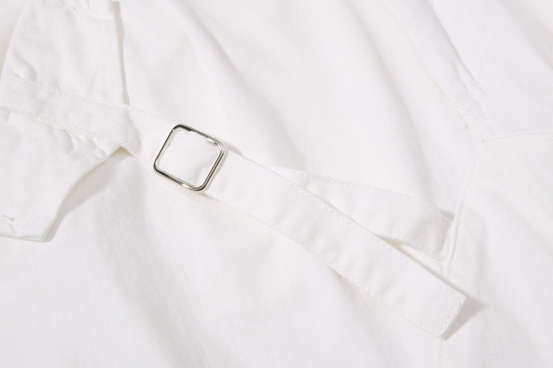 White shorts metal buckle detail on side strap, close-up