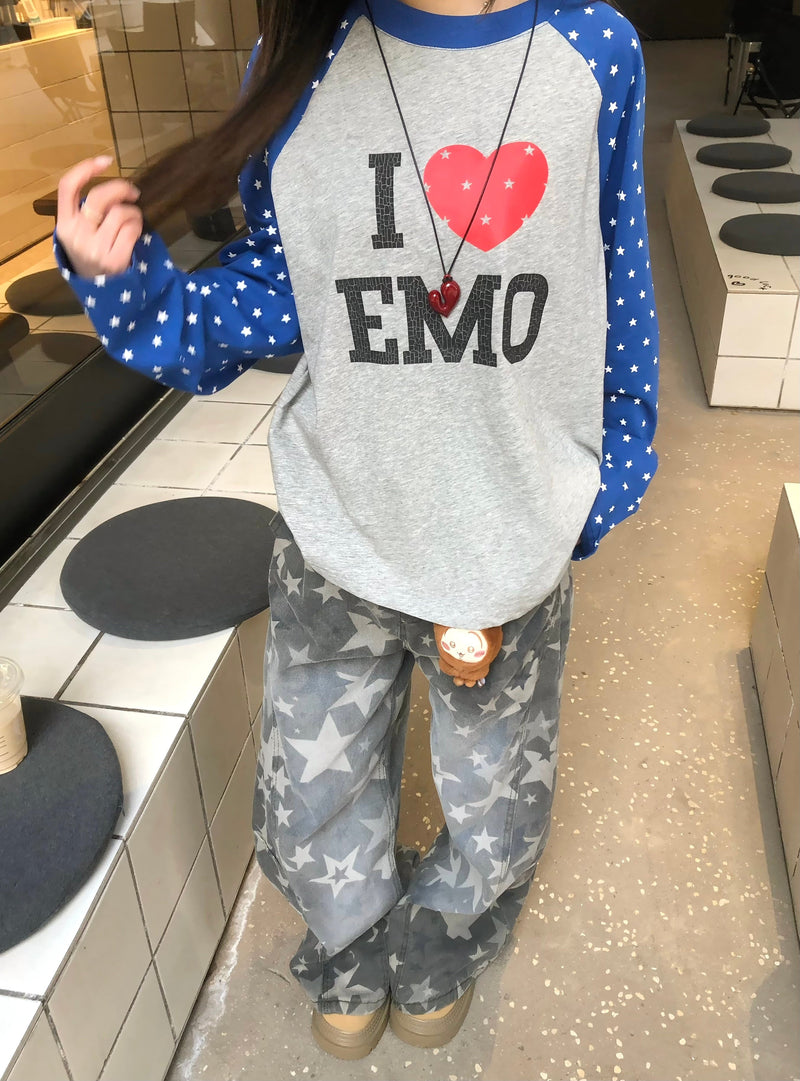 Model wearing gray I Love EMO raglan long sleeve tee with blue star-print sleeves