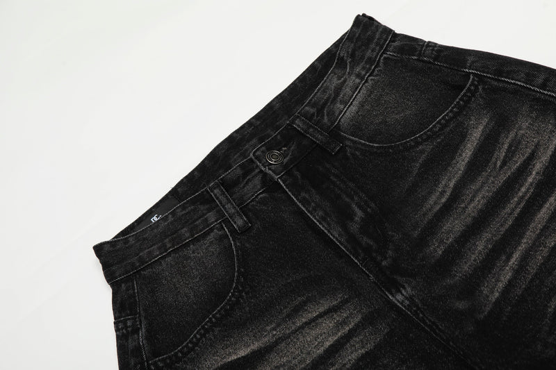 Close-up of black jeans waistband, button closure and belt loops