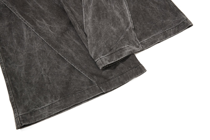 Dark charcoal denim hem close-up with wide-leg cuff and stitched edge