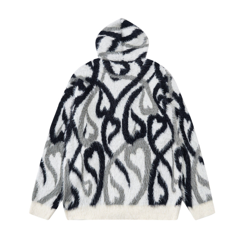 Back view of black and white faux-fur zip hoodie with abstract flame pattern and hood up
