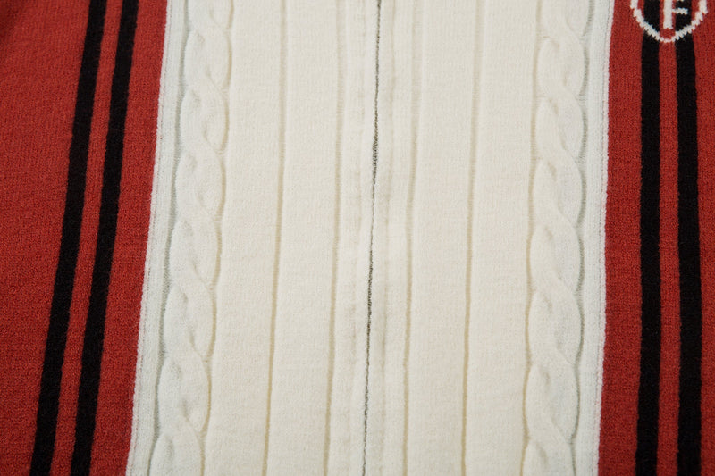 Close-up of cream knit body framed by red striped side panels