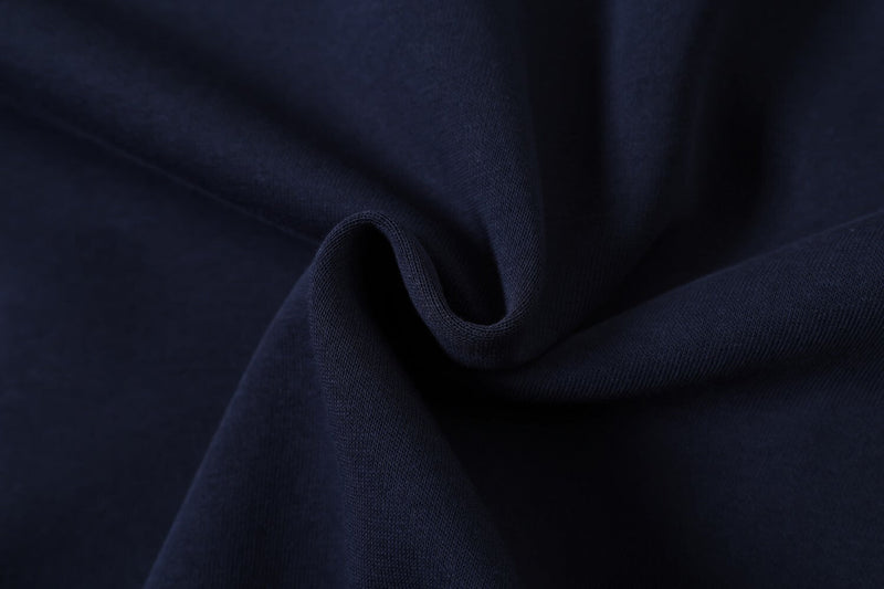 Close-up of navy fabric texture with soft folded drape