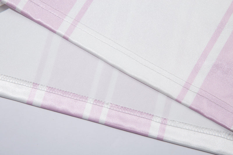 Close-up of the white jersey hem with pink stripe print and stitched edge