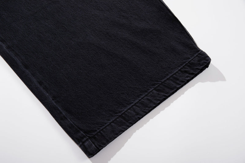 Close-up of dark wash jean hem with clean stitched cuff