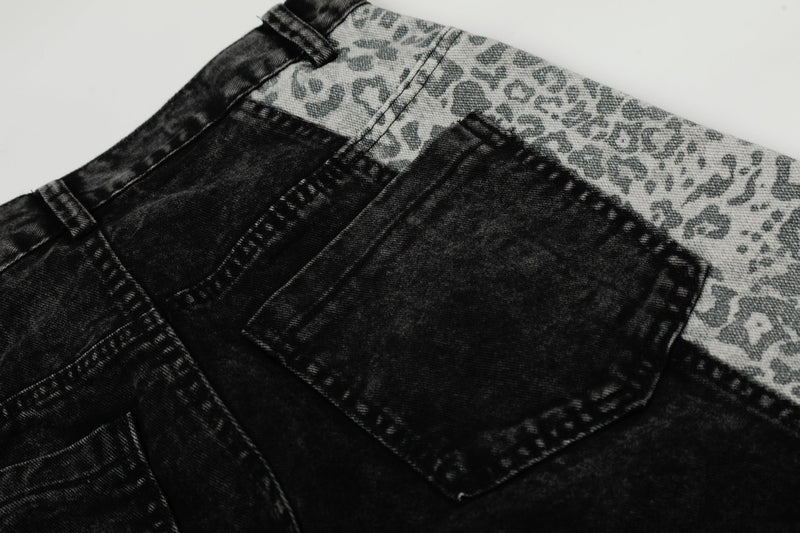Close-up of black patch pocket and leopard panel on denim jeans