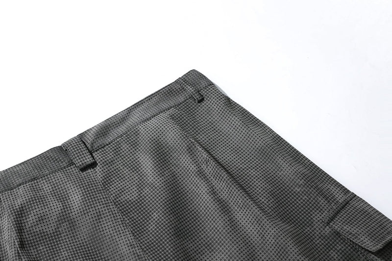 Close-up of black mesh shorts back waist in dark gray textured mesh