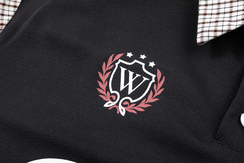 Black oversized polo shirt with plaid shoulder panels and vintage crest logo on the chest
